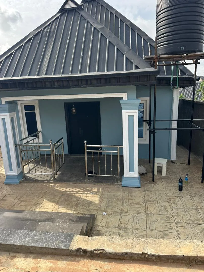 Wide blue grey bungalow facade with dark roof trim