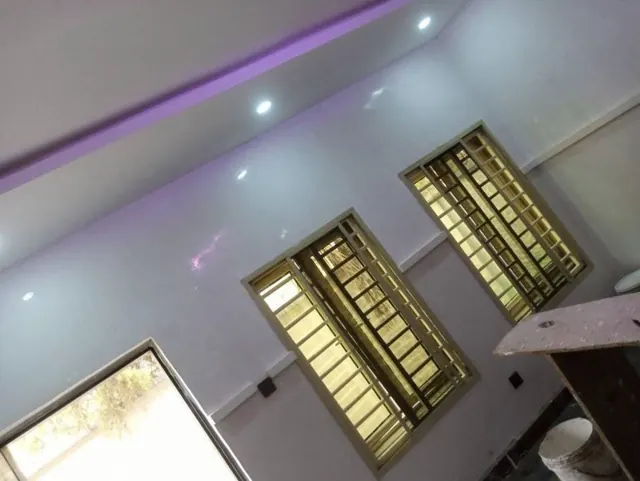 Decorative ceiling detail beside bright windows