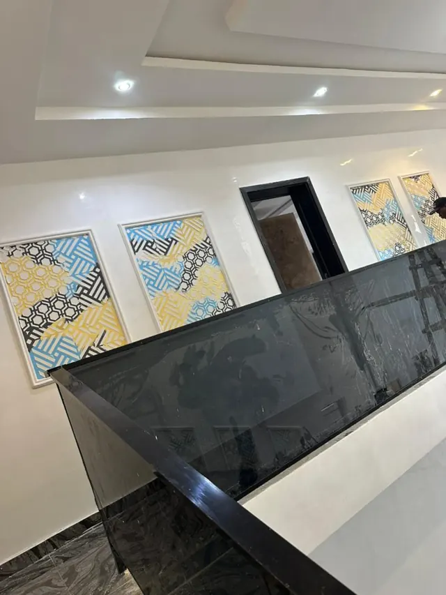Dark grey feature wall beneath a white recessed ceiling