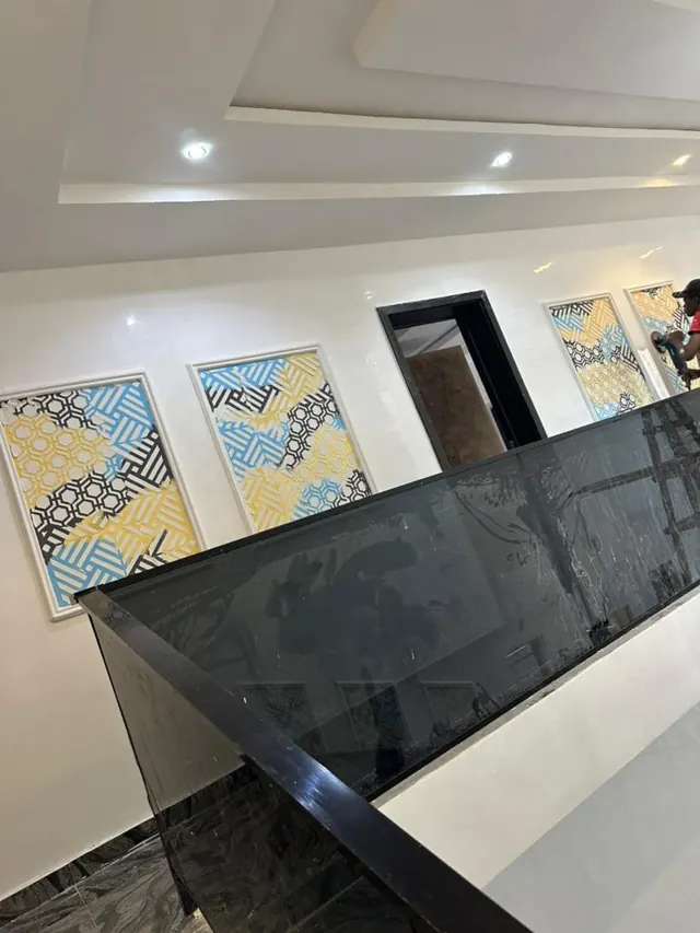 Wide view of a grey feature wall with framed artwork