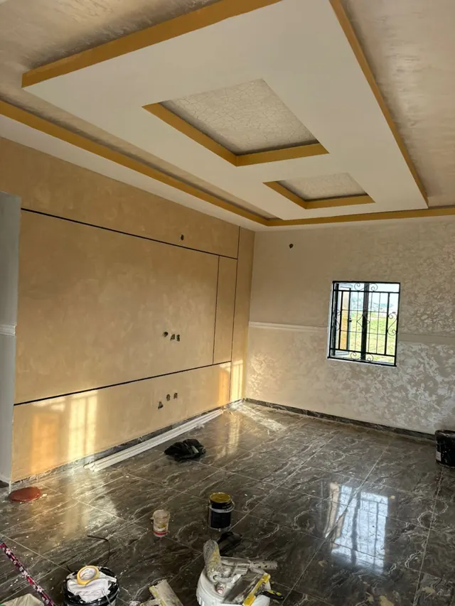 Coffered ceiling above a polished dark marble-effect floor