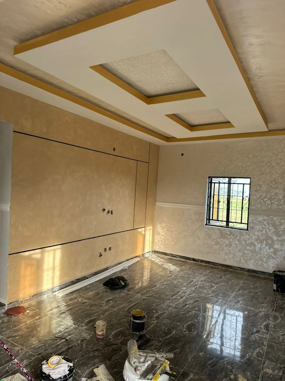 Coffered ceiling above a polished dark marble-effect floor