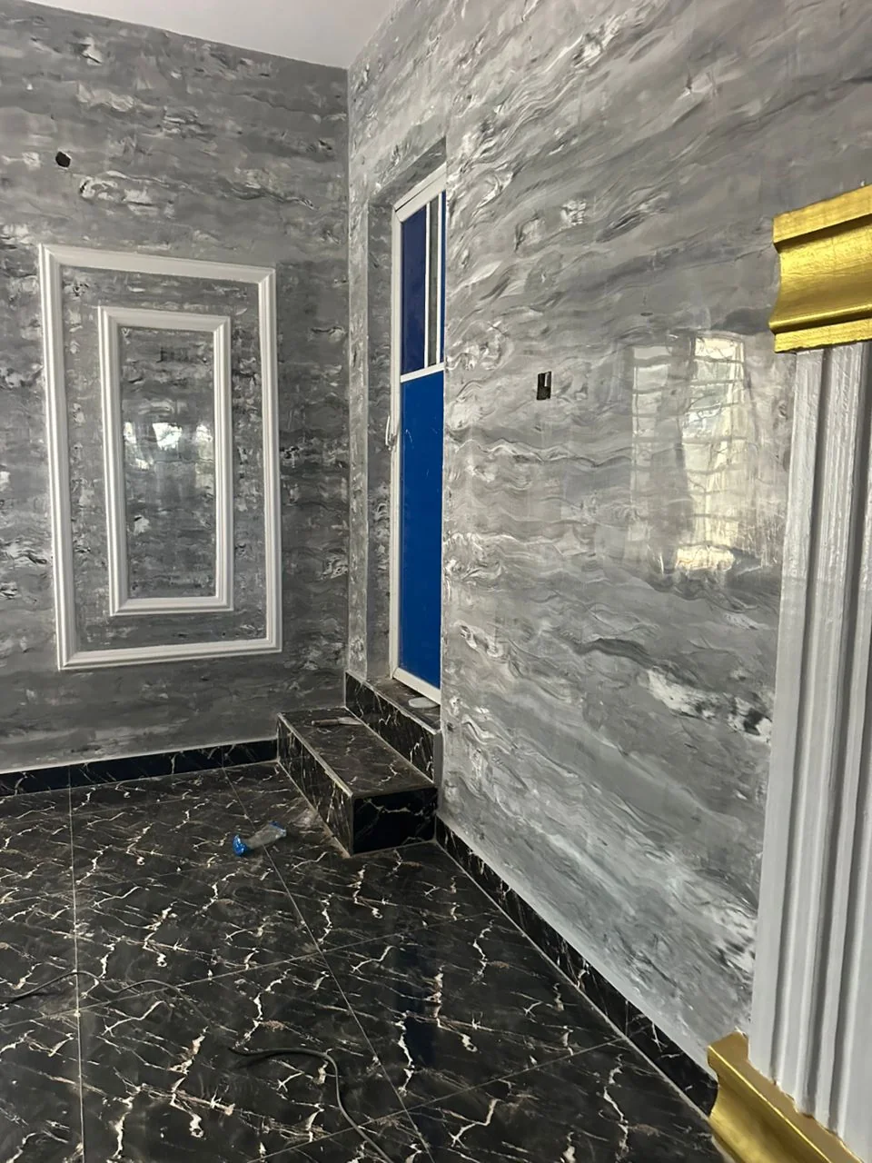 Decorative grey wall panels around a doorway