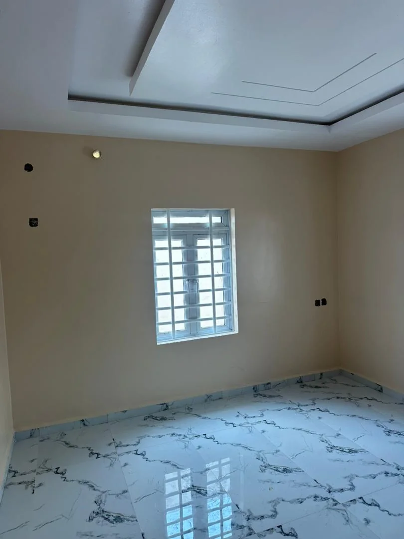 Light neutral bedroom with a crisp recessed ceiling