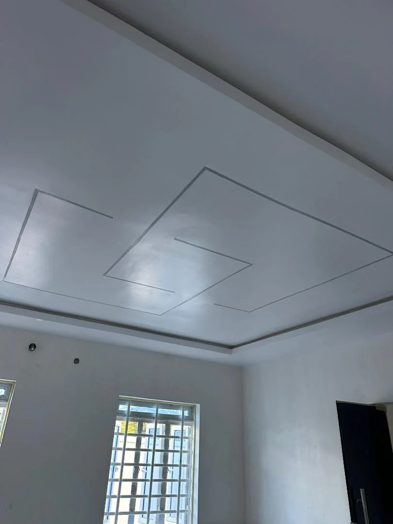 White recessed ceiling above a light neutral wall